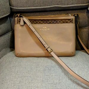 Coach tan crossbody with gold accents and signature pattern zip up case